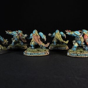 Six painted dwarf miniatures in blue armor stand in a row on grassy bases, with name banners reading Underbraid, Grim Tornjaw, Uli Underfoot, Trogan Alebrew, Train Thrice-Cursed, and Barik Farblast visible on the bases.