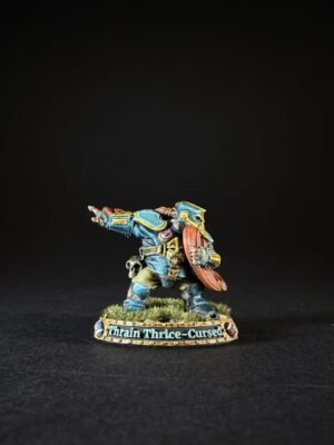Painted miniature of a dwarf warrior in blue armor with a red beard, holding a shield, standing on a grassy base labeled 'Thrain Thrice-Cursed'.