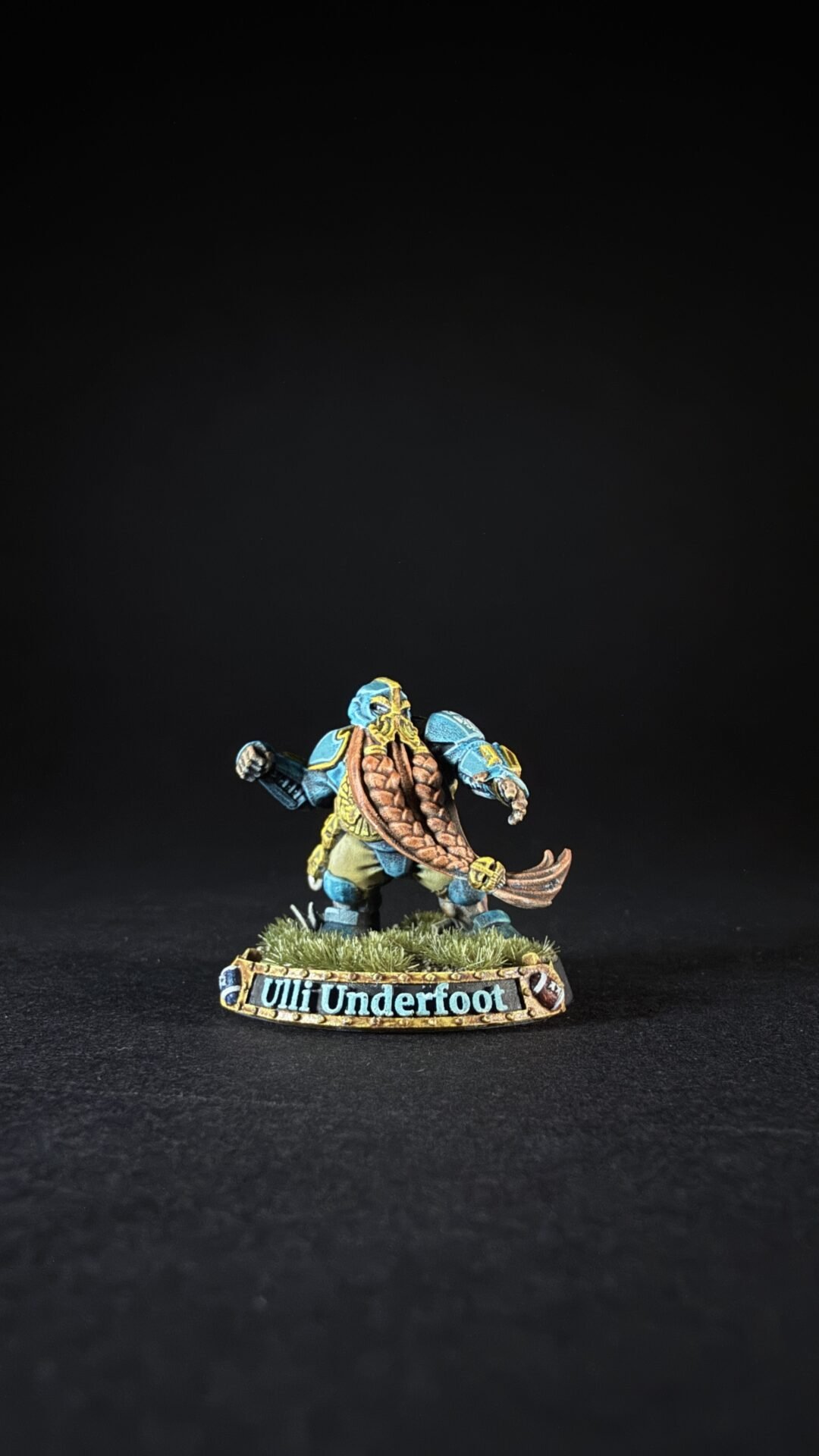 Painted tabletop miniature: blue-armored dwarf figure on a grassy base, nameplate reads 'Ult Underfoot'.