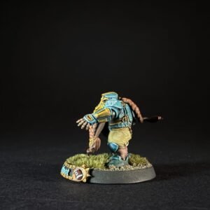 Back view of a painted tabletop miniature: a blue-and-yellow armored warrior with a brown tail, standing on a grassy base.