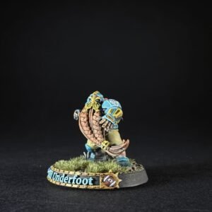Painted fantasy miniature figure in blue armor, wielding a large curved shield, standing on a grassy round base labeled 'Underfoot'.