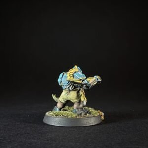 Blue-armored orc-style miniature posed in a combat stance on a grassy round base, ready to fire a punch.