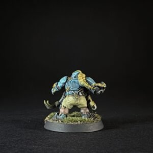 Painted tabletop miniature of a blue-armored orc with yellow hair, standing on a grassy base.