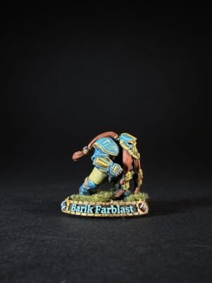 Miniature figure of a muscular armored warrior in blue and gold, crouching on a grassy base marked 'Barik Farblast'.