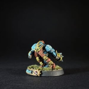 Painted fantasy miniature of a blue-armored reptilian warrior crouching on a grassy base, with a small banner reading 'Blast'.