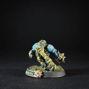 Painted fantasy miniature: blue armored, bearded creature in a crouched pose on a grassy base.