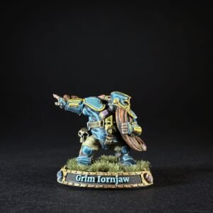 Painted dwarf warrior miniature in blue armor, pointing forward with a shield, on a grassy base labeled Grim Ironjaw.