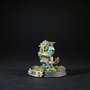 Painted tabletop miniature of a armored warrior with a yellow mask, blue armor, and long brown hair, standing on a grassy base.