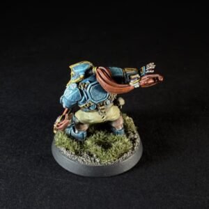 Painted fantasy miniature: a armored blue-clad warrior with a red scarf, raising one arm, on a grassy round base.