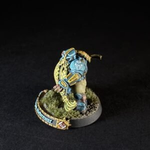 Painted dwarf alebrewer miniature in teal and gold armor, with shield, on a grassy base, banner reading 'Alebrewer'.