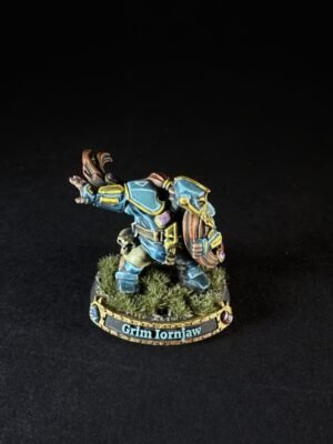 Fantasy dwarf miniature in blue armor with yellow trim, standing on a grassy base labeled Grim Ironjaw.
