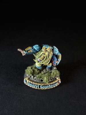 Painted dwarf miniature standing on grassy base, name 'Snorri Sourbrow' visible on the pedestal, arms outstretched in a dynamic pose.