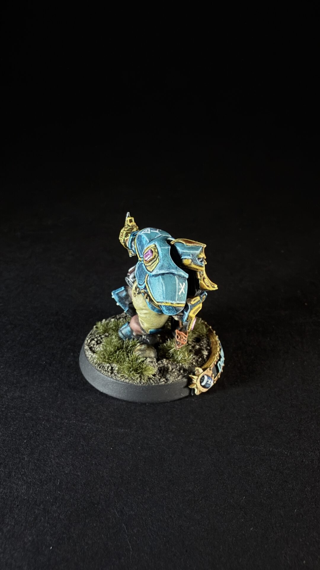 Painted blue armored miniature standing on a grassy diorama base.