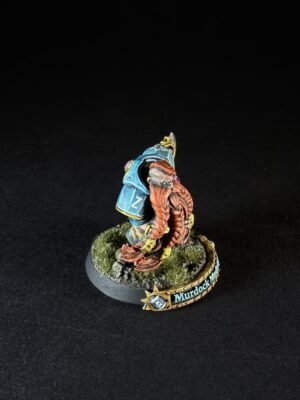 Small painted sci-fi mini figure with orange tentacles and blue armor, standing on a grassy base with a 'Murdock' name banner.