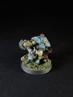 Miniature orc warrior in blue armor, wielding a hammer, on a grassy base of terrain.