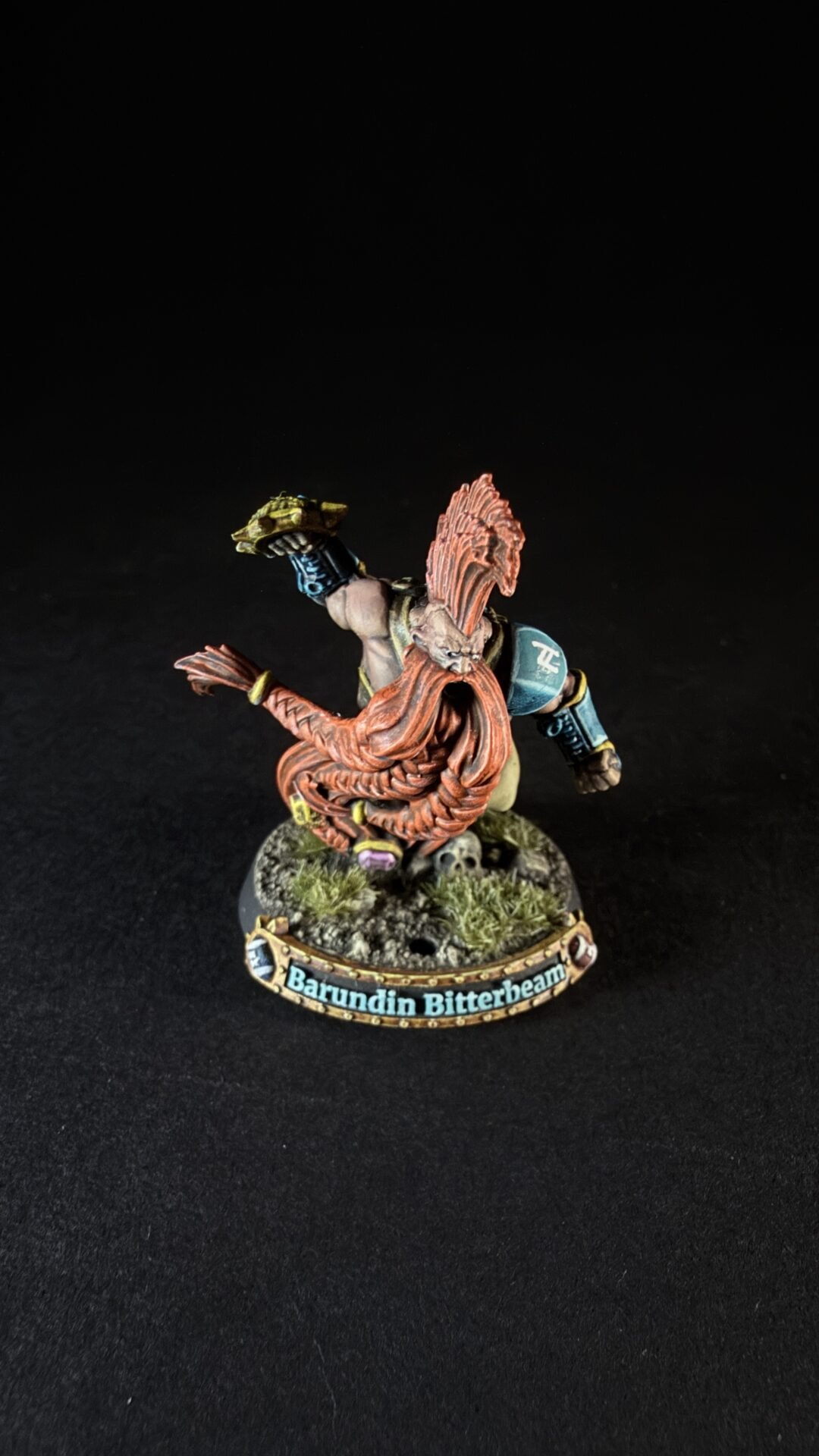 Painted dwarf miniature Barundin Bitterbeam, with a long orange beard, in a battle stance on a rocky base.