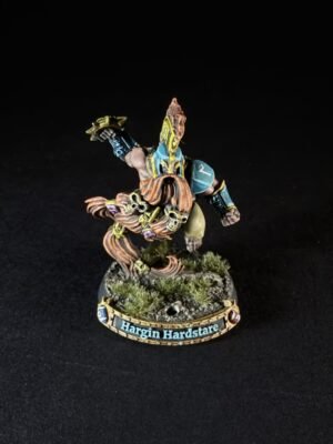 Painted tabletop miniature of a bearded dwarf in teal, yellow, and blue armor, posed on a rocky base with grass; nameplate reads 'Hargin Hardstare'