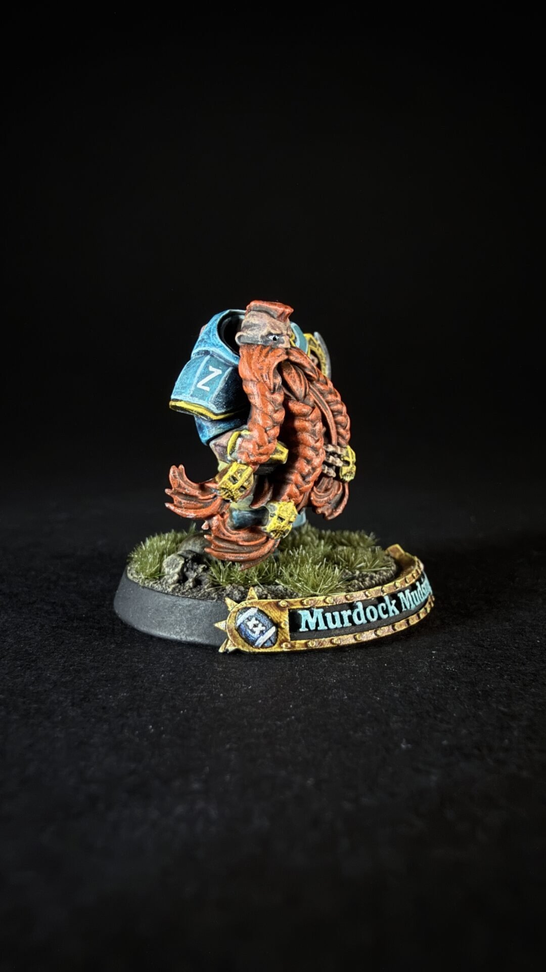 Miniature fantasy creature with orange tentacles and blue armor on a grassy base; nameplate reads 'Murdock Models'.