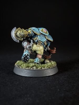 Painted fantasy miniature of a blue-armored orc-like warrior with a large weapon over its shoulder, standing on a grassy base.
