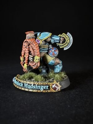 Colorful fantasy dwarf miniature in blue armor, gripping a large battle axe, on a grassy diorama with a name banner on the base.