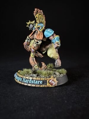 Fantasy dwarf warrior miniature in mid-leap, ornate helmet and blue armor, on a grassy base labeled 'Hargim Hardstare'