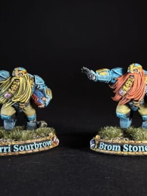 Two blue-armored dwarf miniatures with long beards stand on grassy bases, bases labeled Snorri Sourbrow and Brom Stonefist.