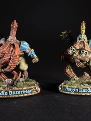 Two painted dwarf miniatures on grassy bases, name plaques read 'Barundin Bitterbeam' and 'Hargin Hardstare'.