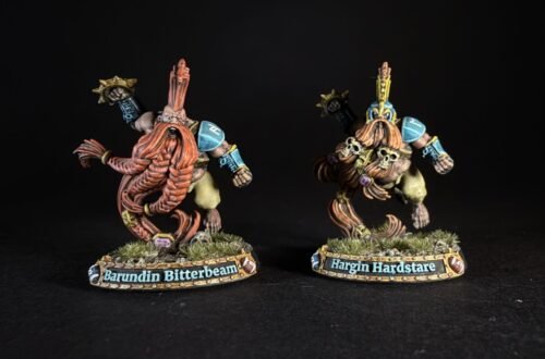 Two painted dwarf miniatures on grassy bases, name plaques read 'Barundin Bitterbeam' and 'Hargin Hardstare'.