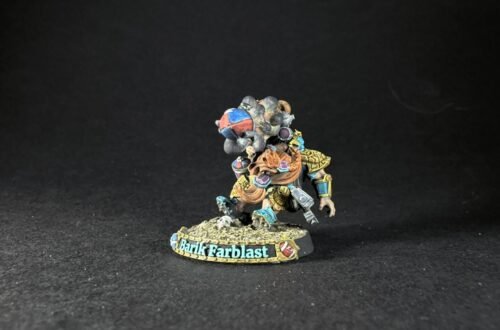 Miniature fantasy warrior figure, colorful armor, standing on rocky base with a banner reading Barik Farblast