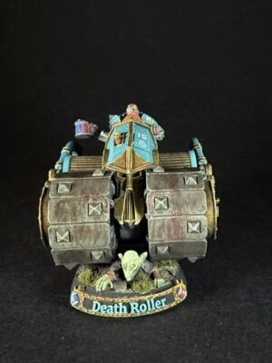 Front view of a painted Death Roller miniature war machine with teal cockpit, armored wheels, and goblin crew on a round base.