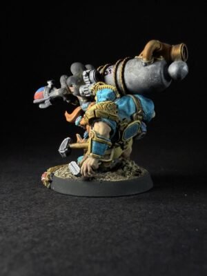 IMG_1124 Dwarf warrior in blue and gold armor kneels on a rocky base, carrying a large steampunk-style cannon strapped to his back tied with ropes.