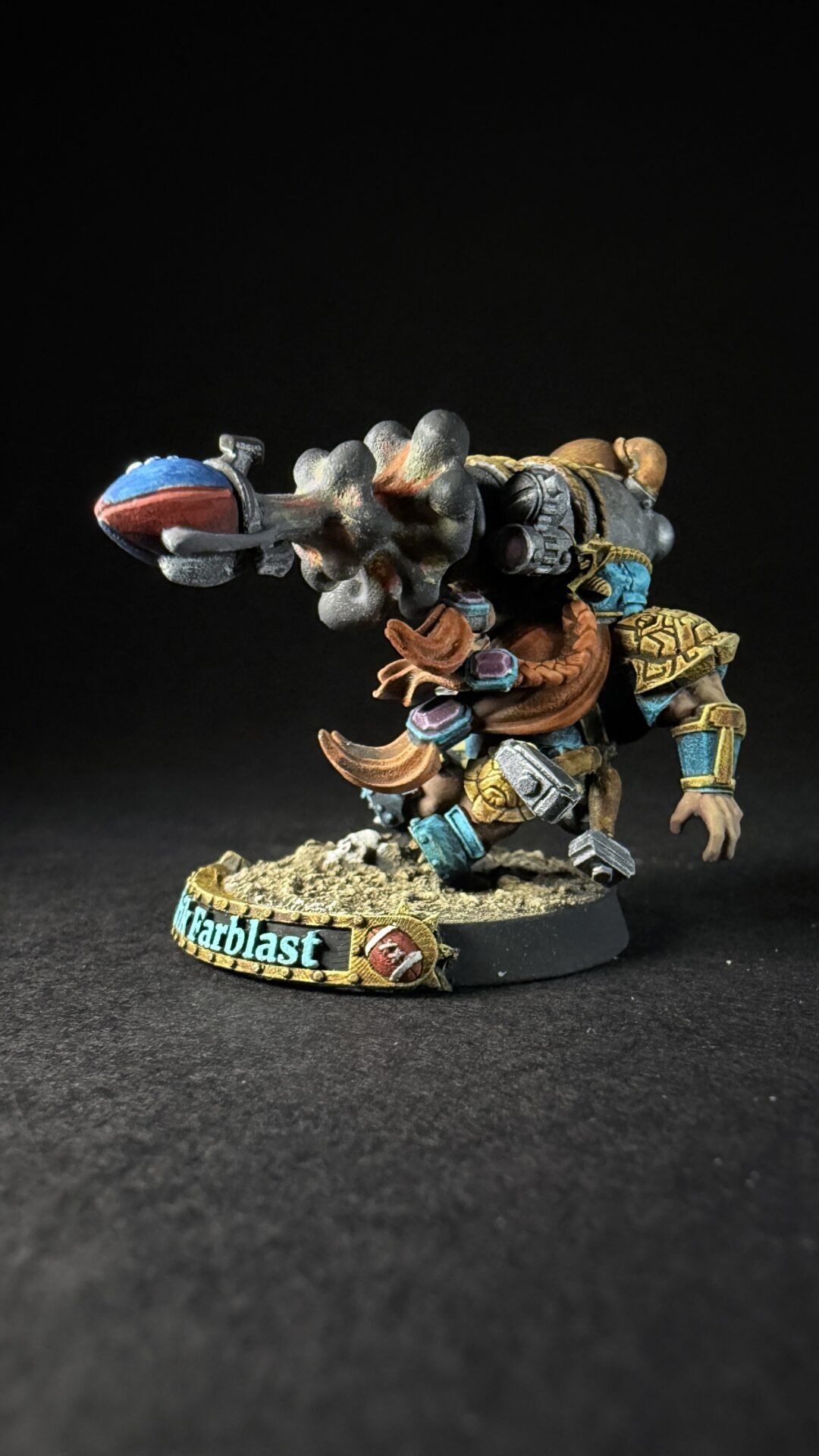 Painted fantasy miniature of a horned armored warrior firing a large cannon, standing on a rocky base with a turquoise banner reading 'Harblast'.