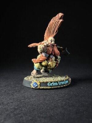 Miniature figure with large orange wings, wearing armor and furring, standing on a textured base labeled 'Grim Ironjaw'