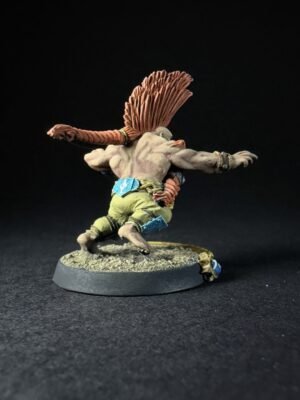 Back view of a running fantasy troll miniature, orange braided hair, gray-green skin, wearing green shorts and blue accessories on a textured base.
