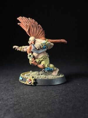 Fantasy miniature figure of a winged humanoid warrior mid-leap, with orange plumage headdress and armor, on a rocky base.