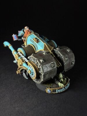 Warhammer Death Roller miniature with teal and gold armor, chained wheels, and a driver atop the siege‑engine on a black background.