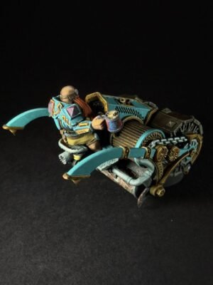 Teal and gold sci‑fi miniature vehicle with a driver perched on top, set against a black backdrop.