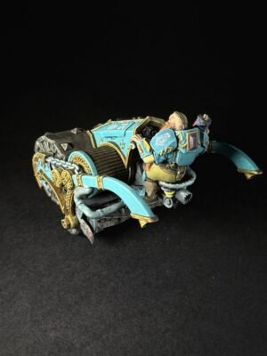 Teal and gold-painted sci‑fi miniature war machine with curved blades and ornate armor on a black background.