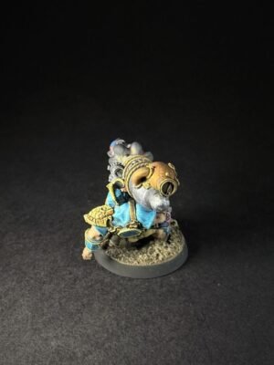 IMG_1147 Painted fantasy miniature of a armored dwarf with steampunk goggles, blue and gold armor, standing on a textured base.