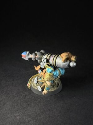 IMG_1148 Painted fantasy miniature of a dwarf warrior with a large ornate cannon strapped to his back, wearing blue and gold armor and standing on a textured round base.