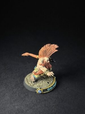 Miniature fantasy warrior figurine with long orange hair in a dynamic pose on a rocky display base.