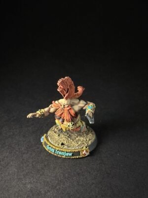 Tabletop miniature of a muscular warrior with orange hair, standing on a rocky base; base reads 'Glim Ironjaw'.
