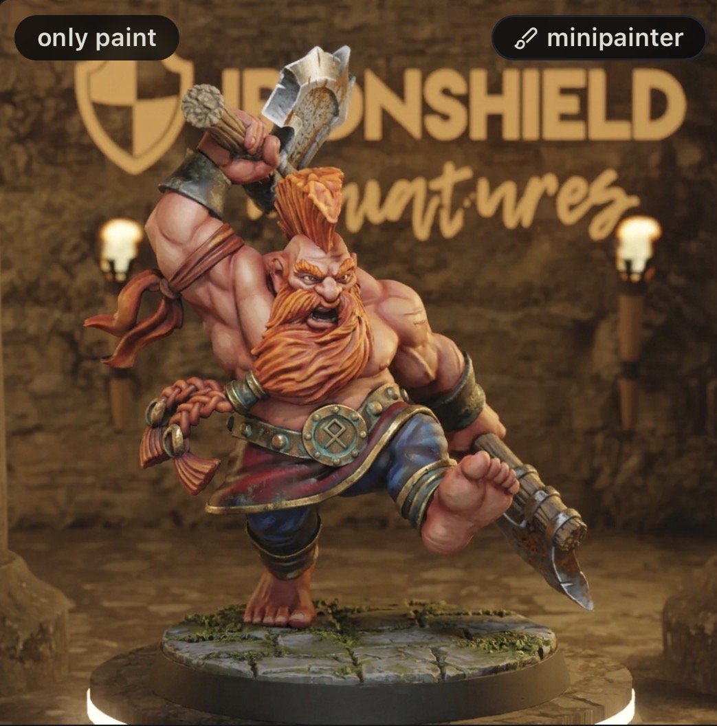 Detailed fantasy miniature of a muscular dwarf with orange beard, raising a large battle-axe overhead while wearing belt and bracers, standing on a textured rocky base.