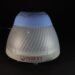 Cone-shaped, ribbed lamp with a blue top and gray base on a dark surface; brand reads 'FOUR'S SCIENTIFIC'.