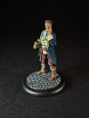 IMG_1458 Miniature fantasy explorer figure wearing a blue coat with yellow trim, red pants, and boots, holding a small telescope and standing on a textured cobblestone base.