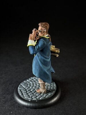 IMG_1464 Figurine of a person in a blue coat peering through a telescope, with a bundle of wood on their back, standing on a cobblestone base.
