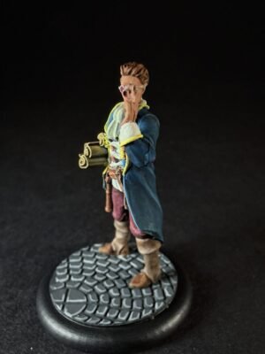 IMG_1465 Miniature male explorer figure in a blue coat with yellow trim, standing on a cobblestone base, shouting with hands near his mouth and a rolled map under his arm.