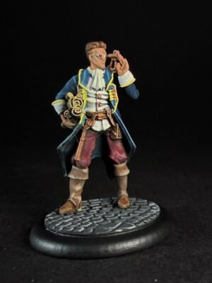 IMG_1466 Miniature pirate captain in a blue coat with yellow trim, holding a telescope to his eye, standing on a textured circular base.