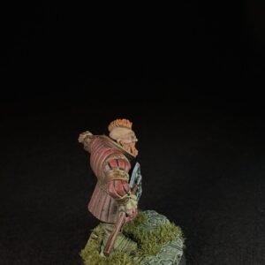 Tabletop miniature of a red-armored knight, holding a weapon, standing on a grassy, mossy base.
