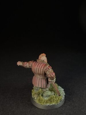 IMG_1503 Back view of a medieval knight miniature in red-brown plate armor, standing on a grassy base with a sword sheathed at the side.